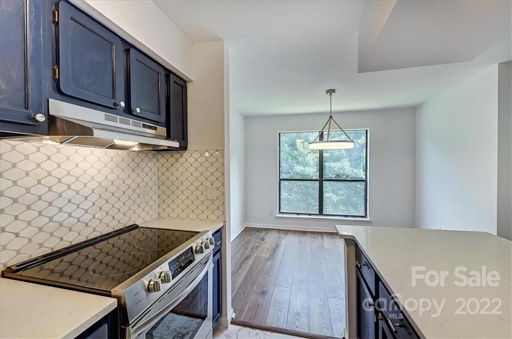 11019 Running Ridge Rd. Charlotte, NC 28226 - Photo 6 of 31 a kitchen with a stove and a microwave