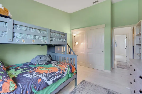 a bedroom with a bed and cabinets