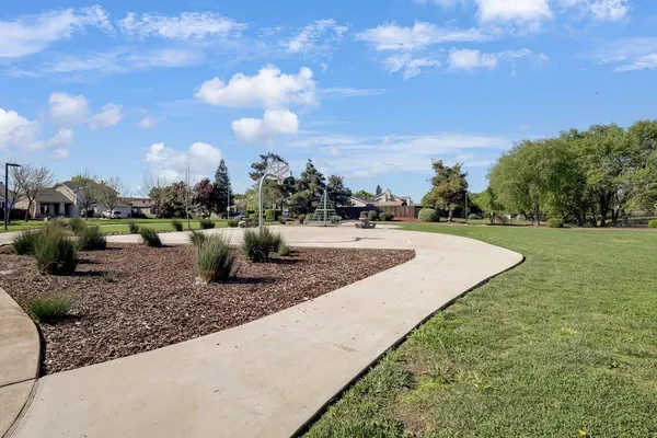 a view of a water fountain and a big yard