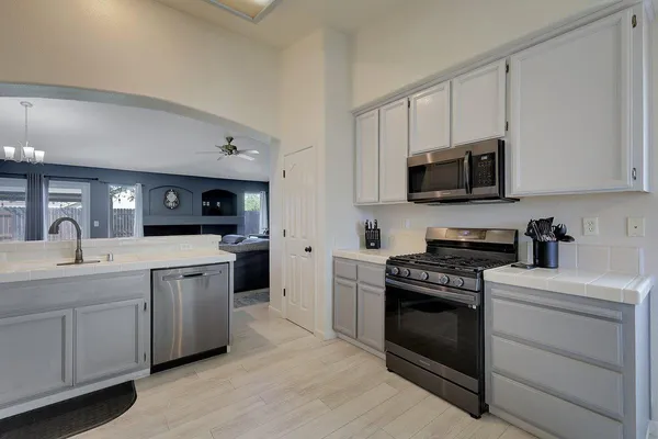 a kitchen with a sink stove and microwave
