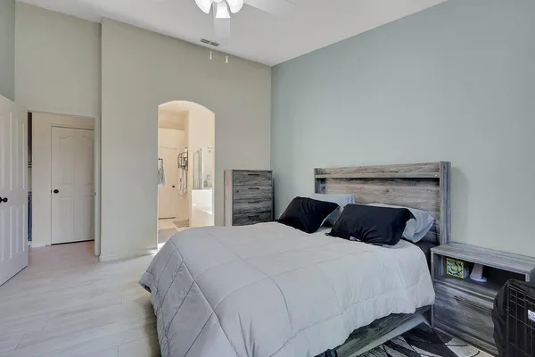 a bedroom with a bed and a chandelier