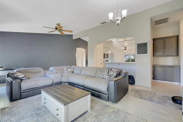 a living room with furniture and a chandelier