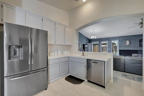 a kitchen with cabinets stainless steel appliances and a counter space