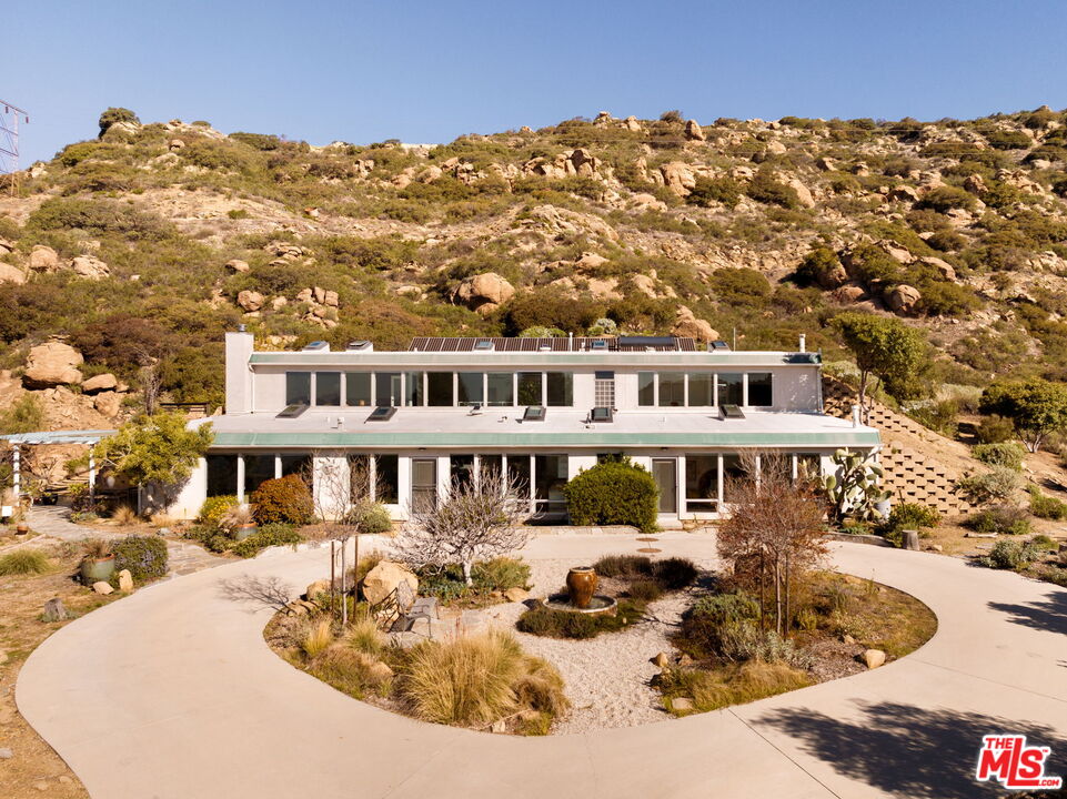 7401 Studio Road Canoga Park, CA 91304 - Photo 1 of 30 a view of a white house with a swimming pool