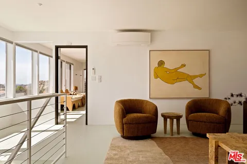 a living room with furniture and a floor to ceiling window