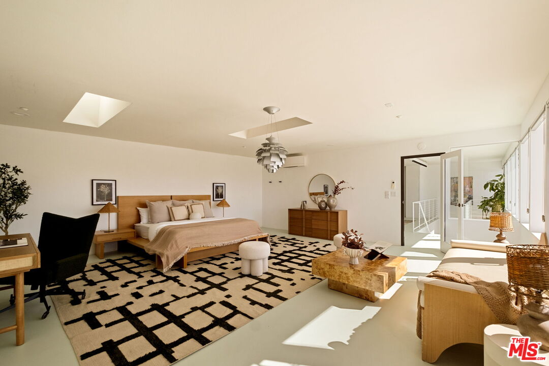 7401 Studio Road Canoga Park, CA 91304 - Photo 15 of 30 a bedroom with a bed and a chandelier