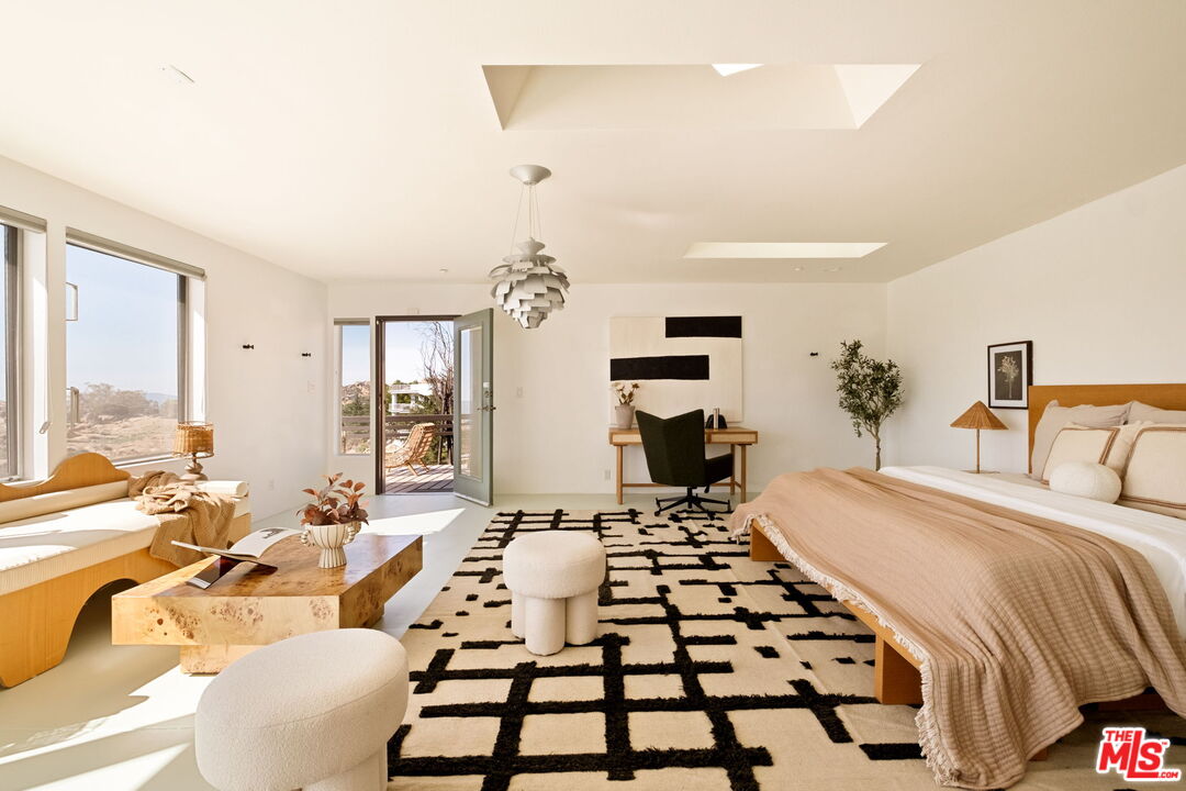 7401 Studio Road Canoga Park, CA 91304 - Photo 16 of 30 a bedroom with a bed and a large mirror with a potted plant