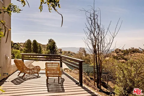 a view of balcony with furniture