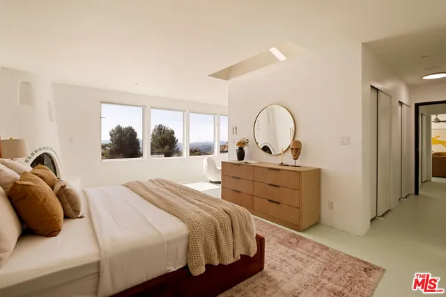 a bedroom with a bed and a dresser