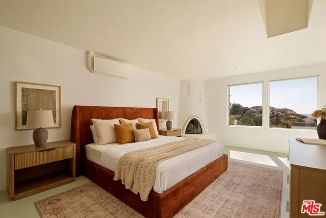 a bedroom with double bed and a large window