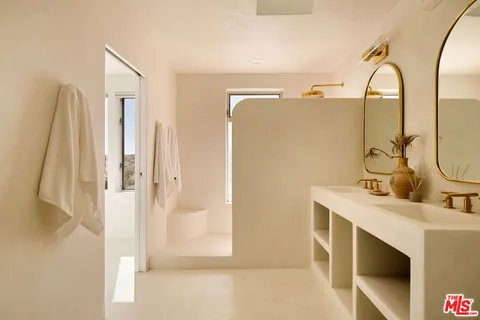 a bathroom with a double vanity sink mirror and