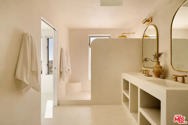 a bathroom with a double vanity sink mirror and