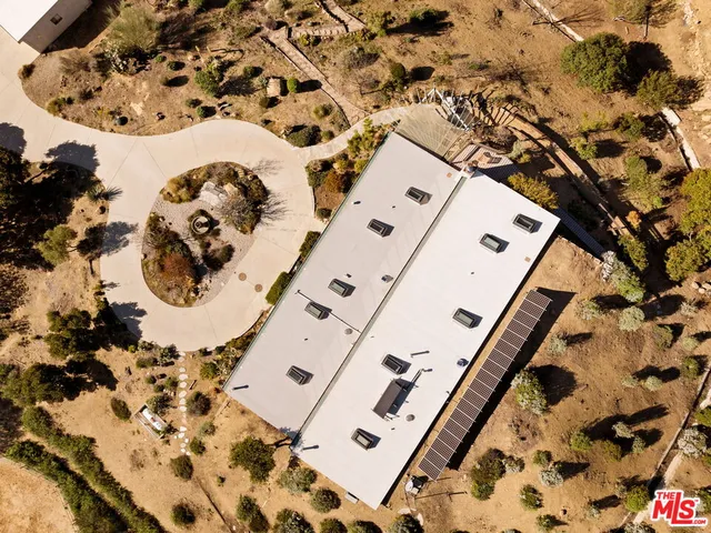 a view of a large building with wooden fence