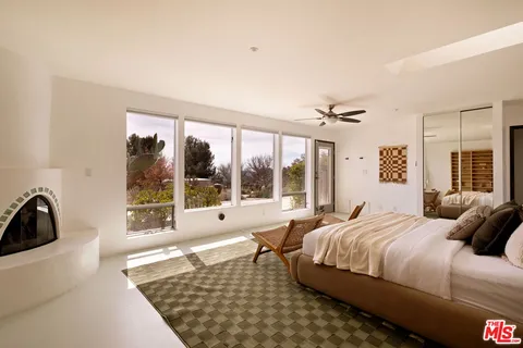 a bedroom with a bed and glass window