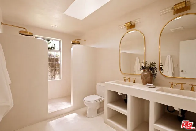 a bathroom with a sink mirror vanity and toilet