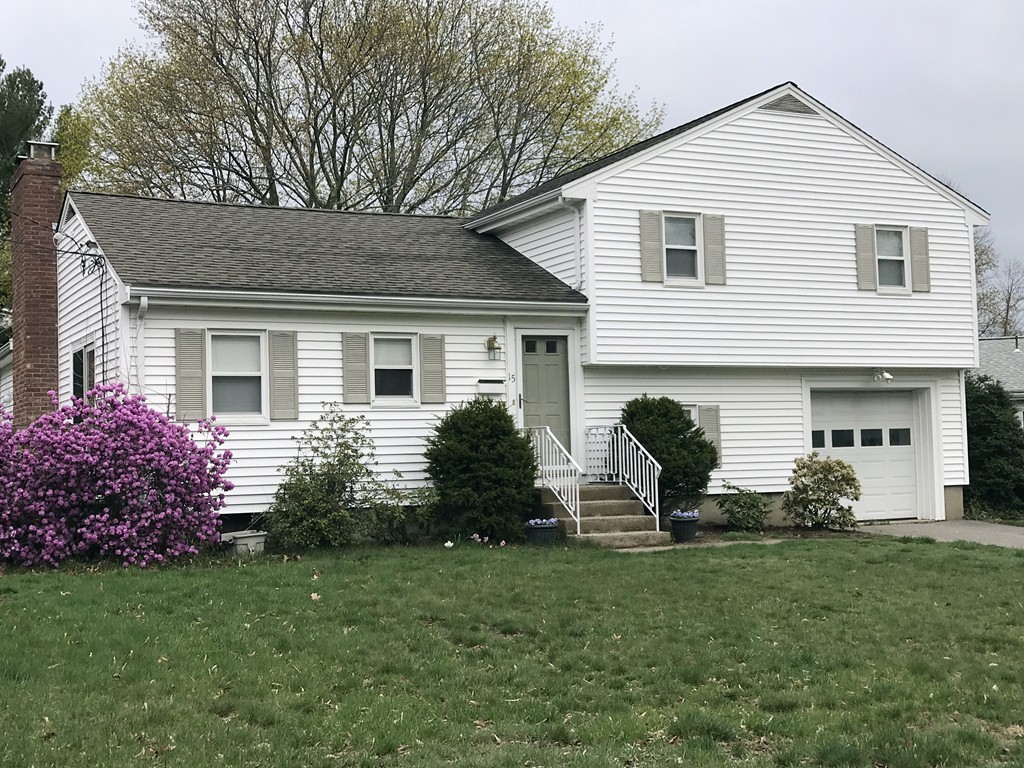 a front view of house with a garden