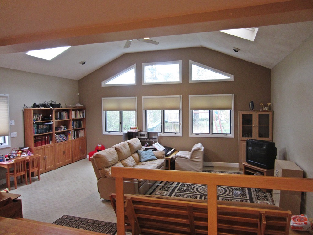 15 Yale Road Needham, MA 02494 - Photo 2 of 5 a living room with furniture a bookshelf and a large window