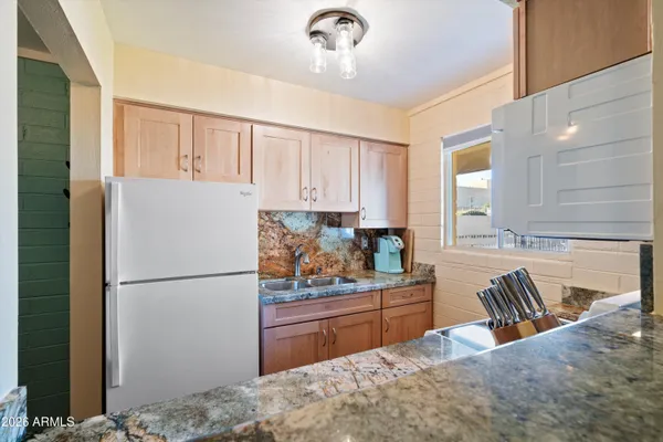 a kitchen with sink a window and appliances