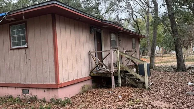 a wooden bench sitting in front of a house