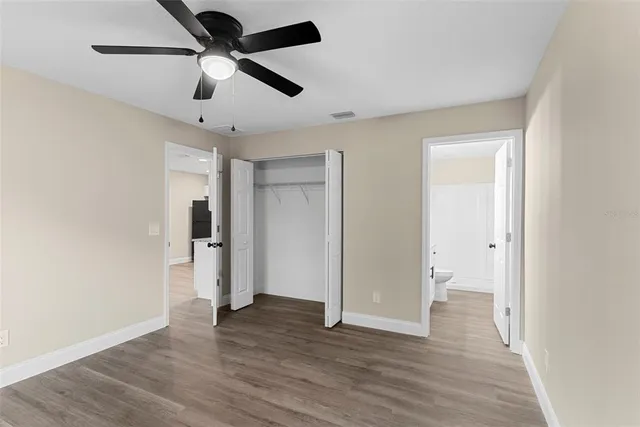 a view of empty room with wooden floor