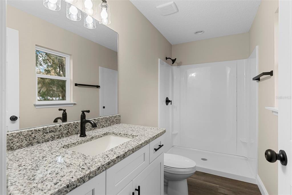 603 Moose Lodge Road, Unit A Bartow, FL 33830 - Photo 15 of 22 a bathroom with a granite countertop sink toilet and shower