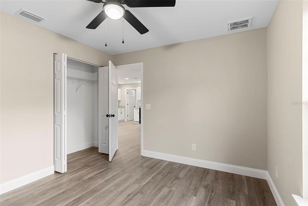 603 Moose Lodge Road, Unit A Bartow, FL 33830 - Photo 19 of 22 an empty room with wooden floor and ceiling fan