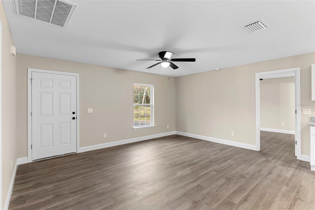 603 Moose Lodge Road, Unit A Bartow, FL 33830 - Photo 21 of 22 a view of an empty room with wooden floor and a window