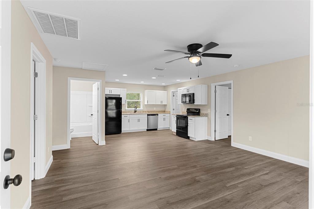 603 Moose Lodge Road, Unit A Bartow, FL 33830 - Photo 5 of 22 a view of a kitchen with wooden floor and a kitchen