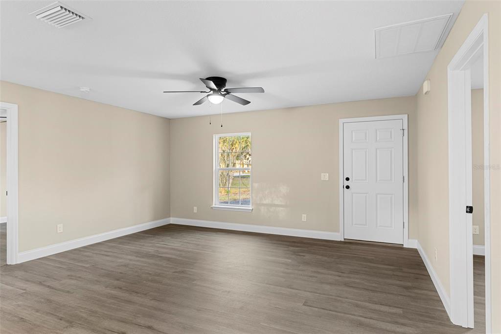603 Moose Lodge Road, Unit A Bartow, FL 33830 - Photo 6 of 22 a view of an empty room with wooden floor and a window