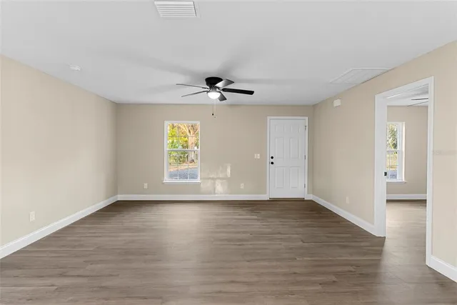 wooden floor in an empty room with a window