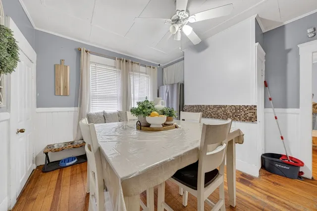 a view of a dining room with furniture and a chandelier