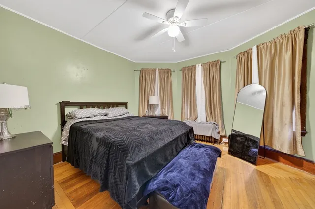 a bedroom with a large bed and a chandelier