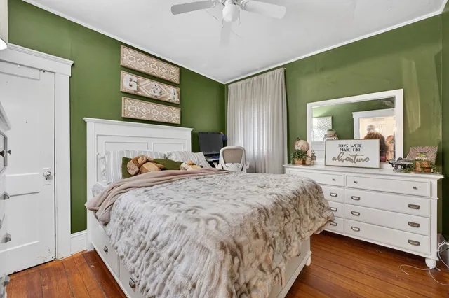 a bedroom with a bed and a dresser