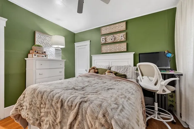 a bedroom with a bed and chair