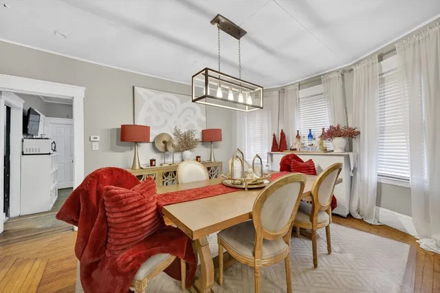 a view of a dining room with furniture window and wooden floor