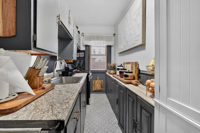 a kitchen view with stainless steel appliances granite countertop a stove and a dining table