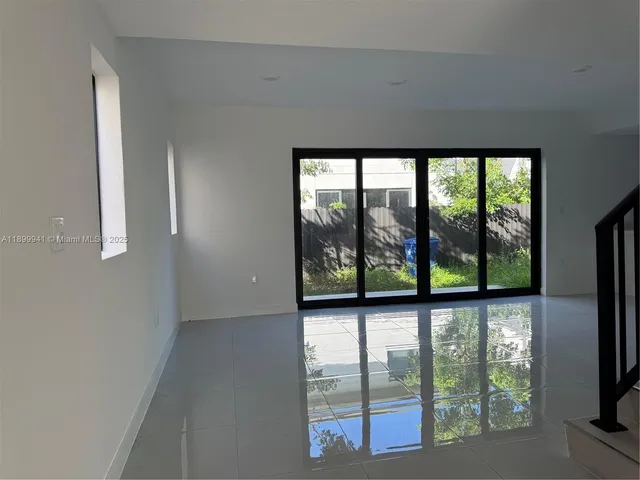 an empty room with large windows