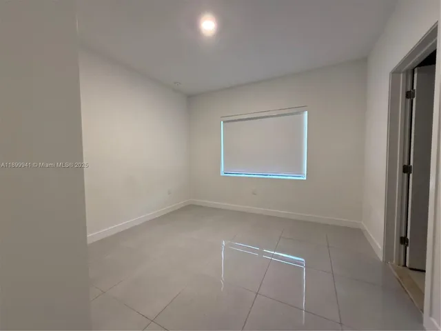 an empty room with a empty space and a window