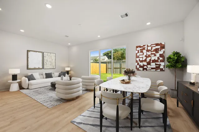 a living room with furniture kitchen and a potted plant