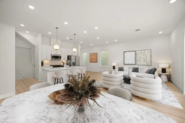 a living room with furniture and a view of kitchen