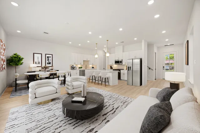 a kitchen with refrigerator and chairs