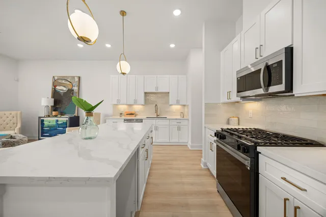 a kitchen with cabinets appliances and a sink