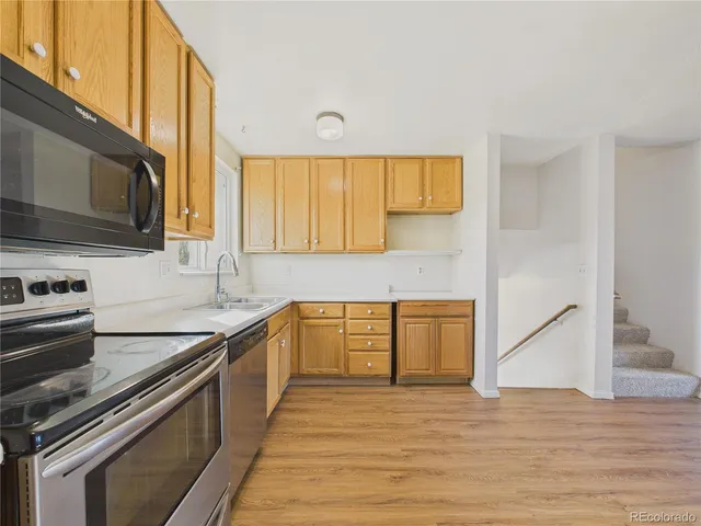 a kitchen with a sink stove and cabinets