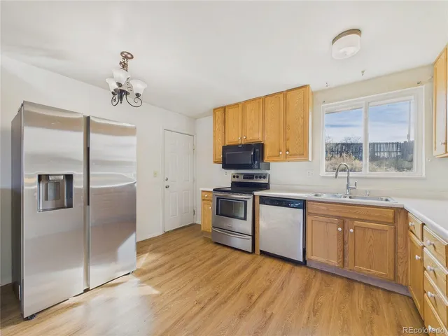 a kitchen with a refrigerator and a sink