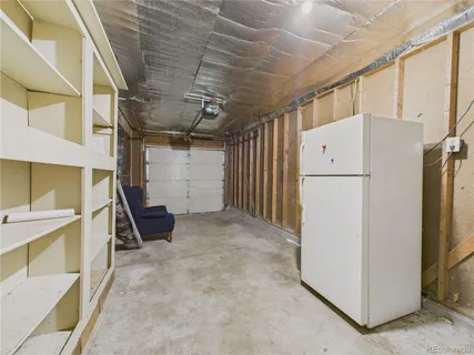 a view of storage and utility room with a refrigerator