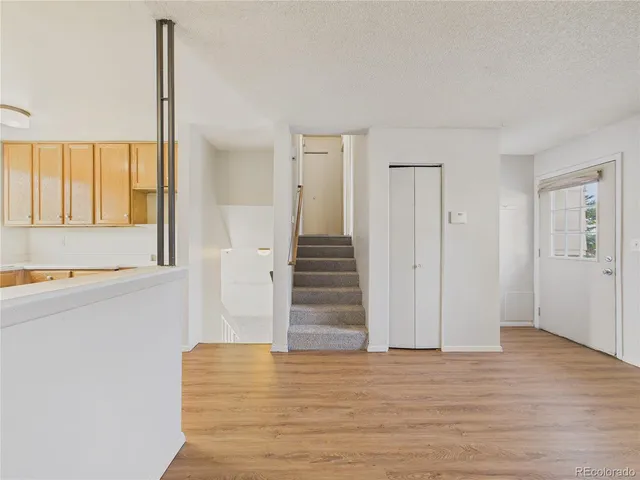 a view of entryway and hall with wooden floor
