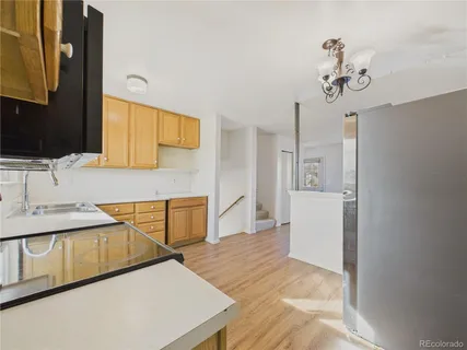 a kitchen with stainless steel appliances granite countertop a sink and a refrigerator