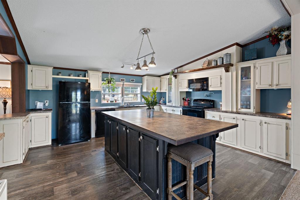 2005 Atticus Court Springtown, TX 76082 - Photo 1 of 15 a kitchen with stainless steel appliances granite countertop a refrigerator a stove top oven a sink dishwasher and microwave with wooden floor