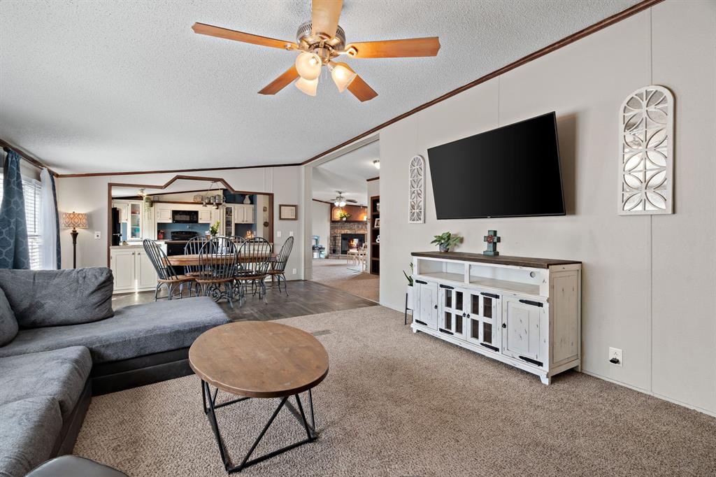 2005 Atticus Court Springtown, TX 76082 - Photo 2 of 15 a living room with furniture and a flat screen tv