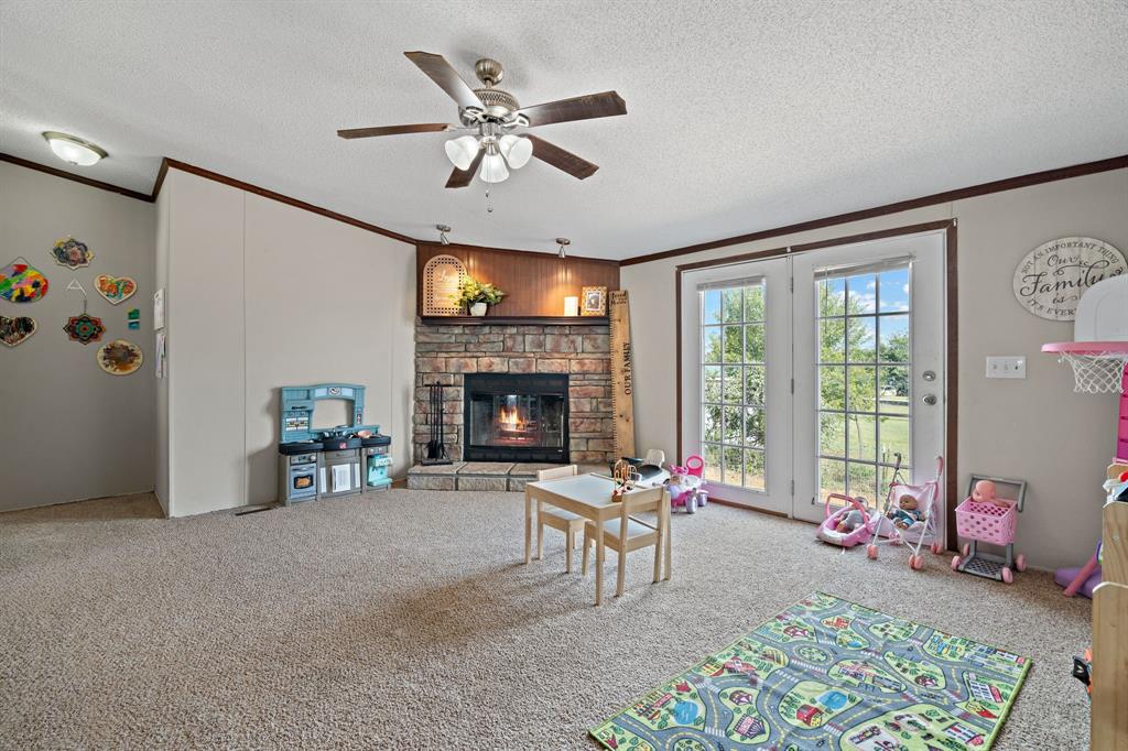 2005 Atticus Court Springtown, TX 76082 - Photo 5 of 15 a living room with furniture and a fireplace